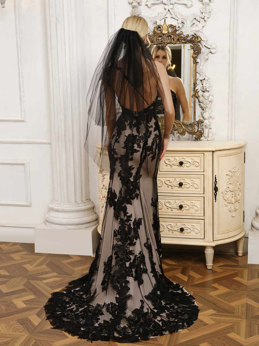 Side view of the one-shoulder mermaid wedding dress, showing tulle and appliques.