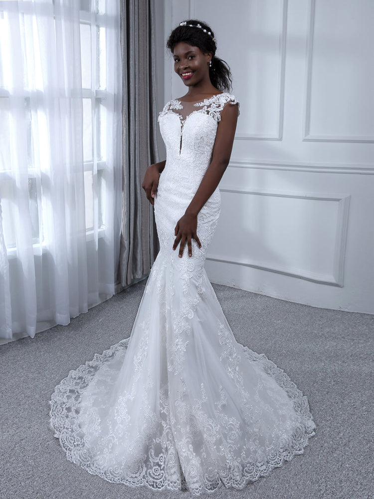 Side profile of a bride wearing the Weitese sheer neck mermaid wedding dress.