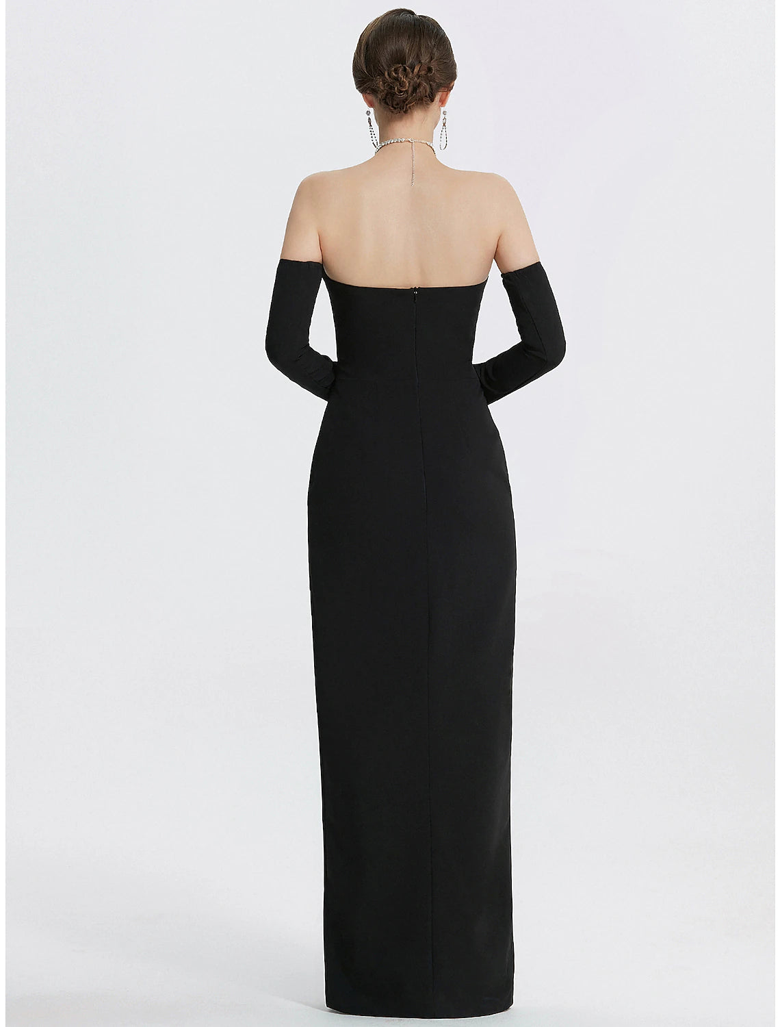 Black mermaid gown with a high slit, side profile.
