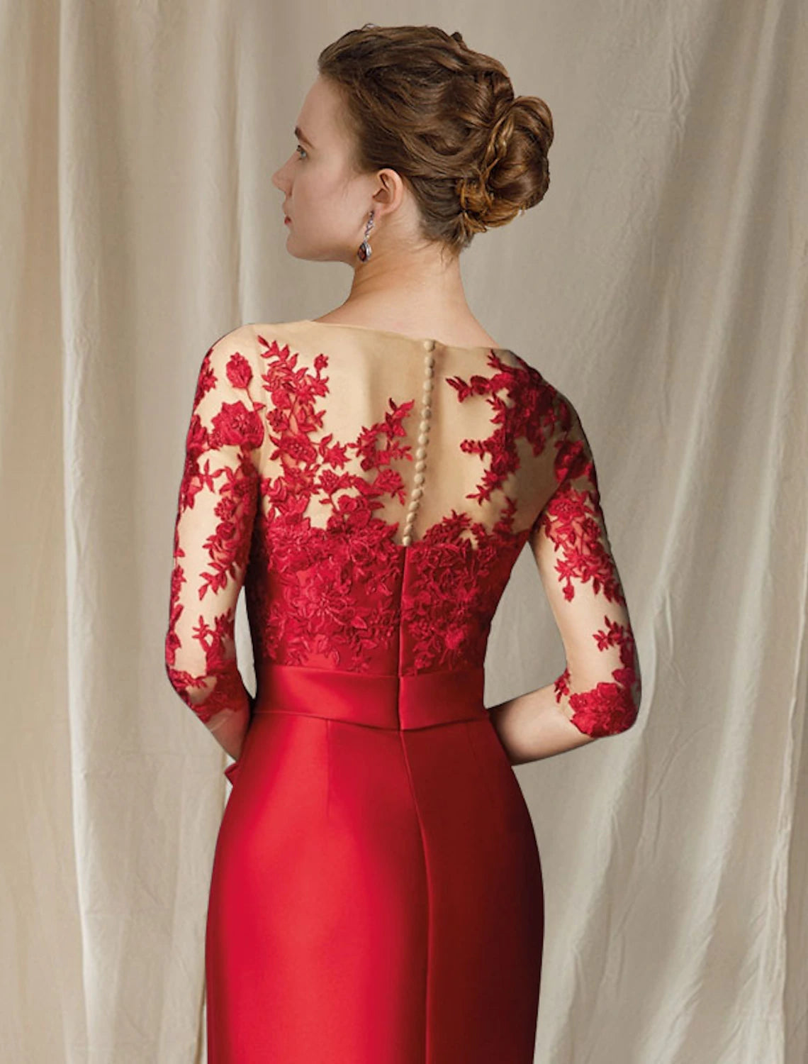 Close-up of the jewel neck and satin lace fabric on the Mother of the Bride Dress.