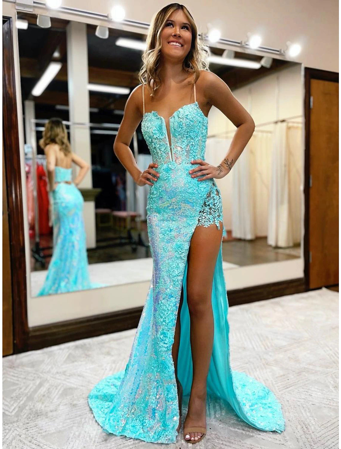Elegant sequined mermaid trumpet dress with V-neck and high slit.