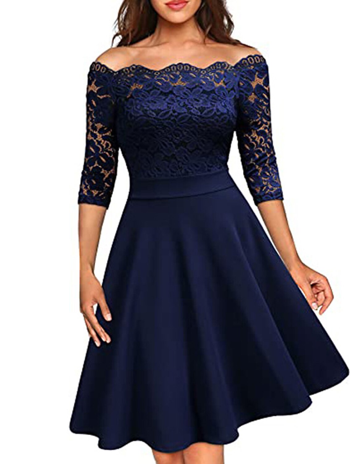 Woman wearing a dark blue off-shoulder lace midi dress.