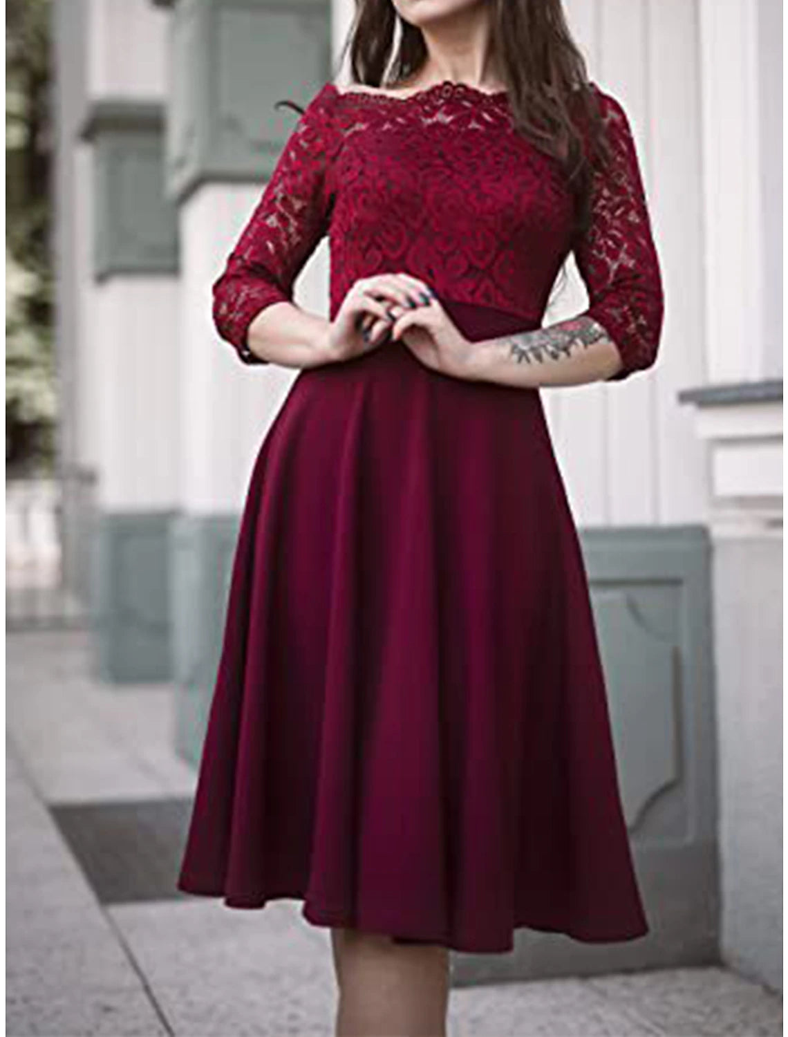Close-up of the lace detail on a dark blue off-shoulder midi dress.