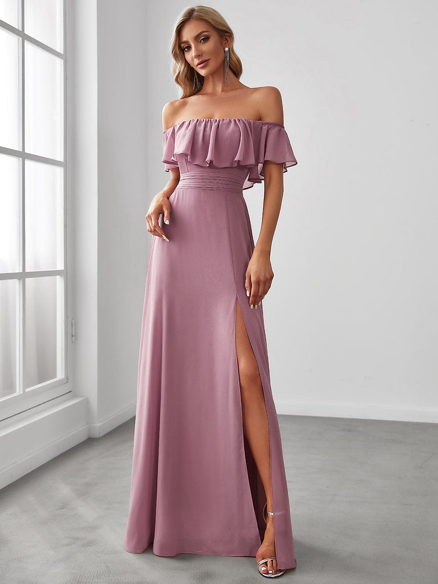 Woman wearing a light blue off-shoulder ruffle thigh slit A-line bridesmaid dress.