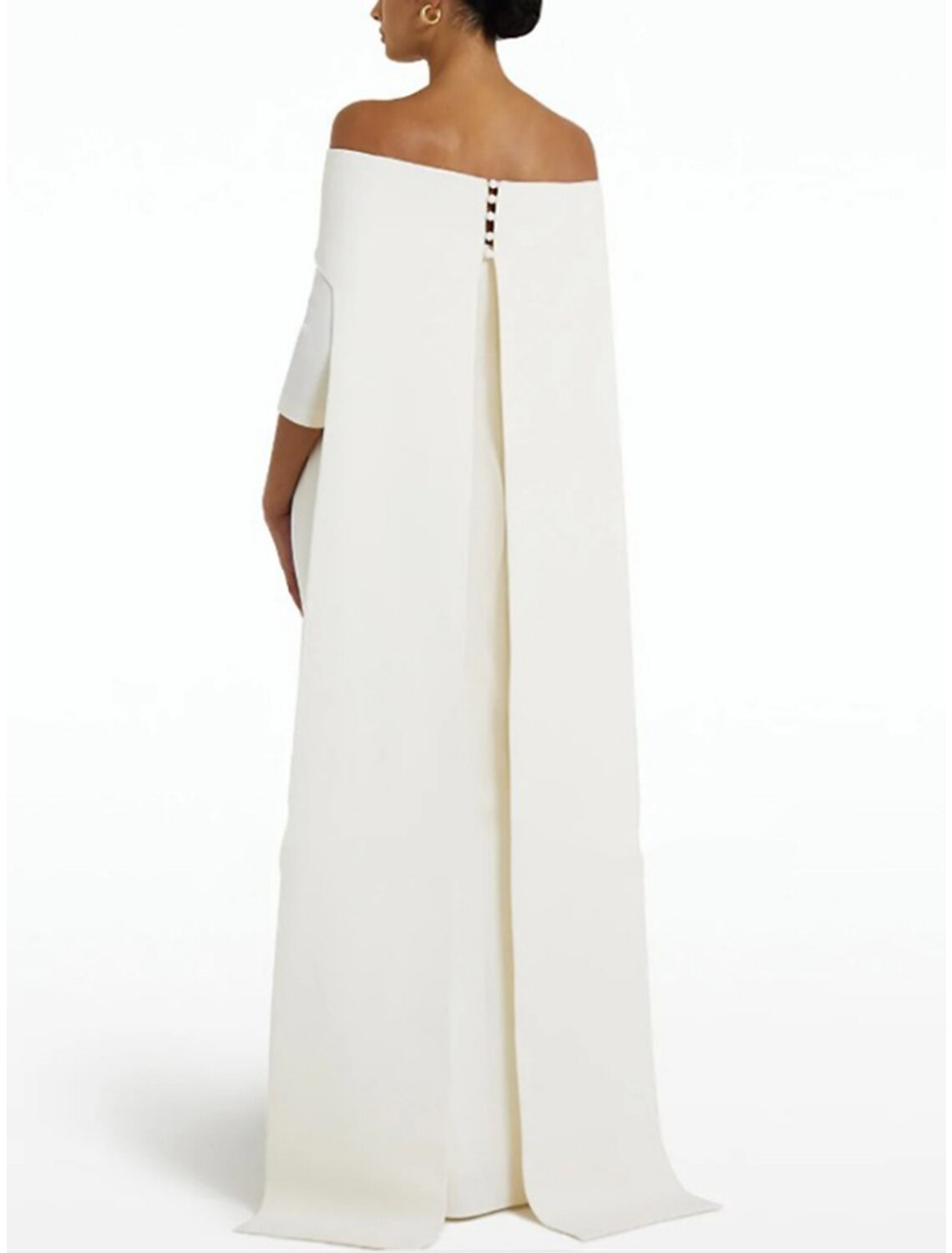 Full-length view of a model posing in the dark blue off-shoulder sheath evening gown.