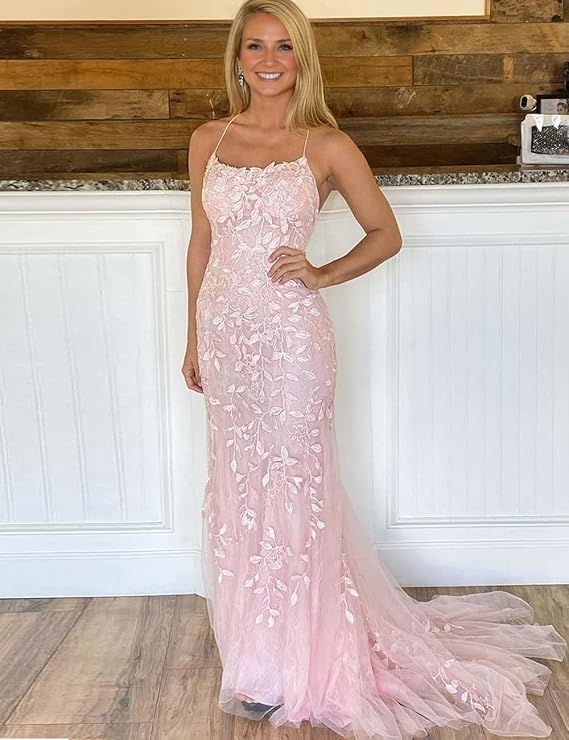 Woman in an elegant off-shoulder trumpet mermaid lace tulle gown.