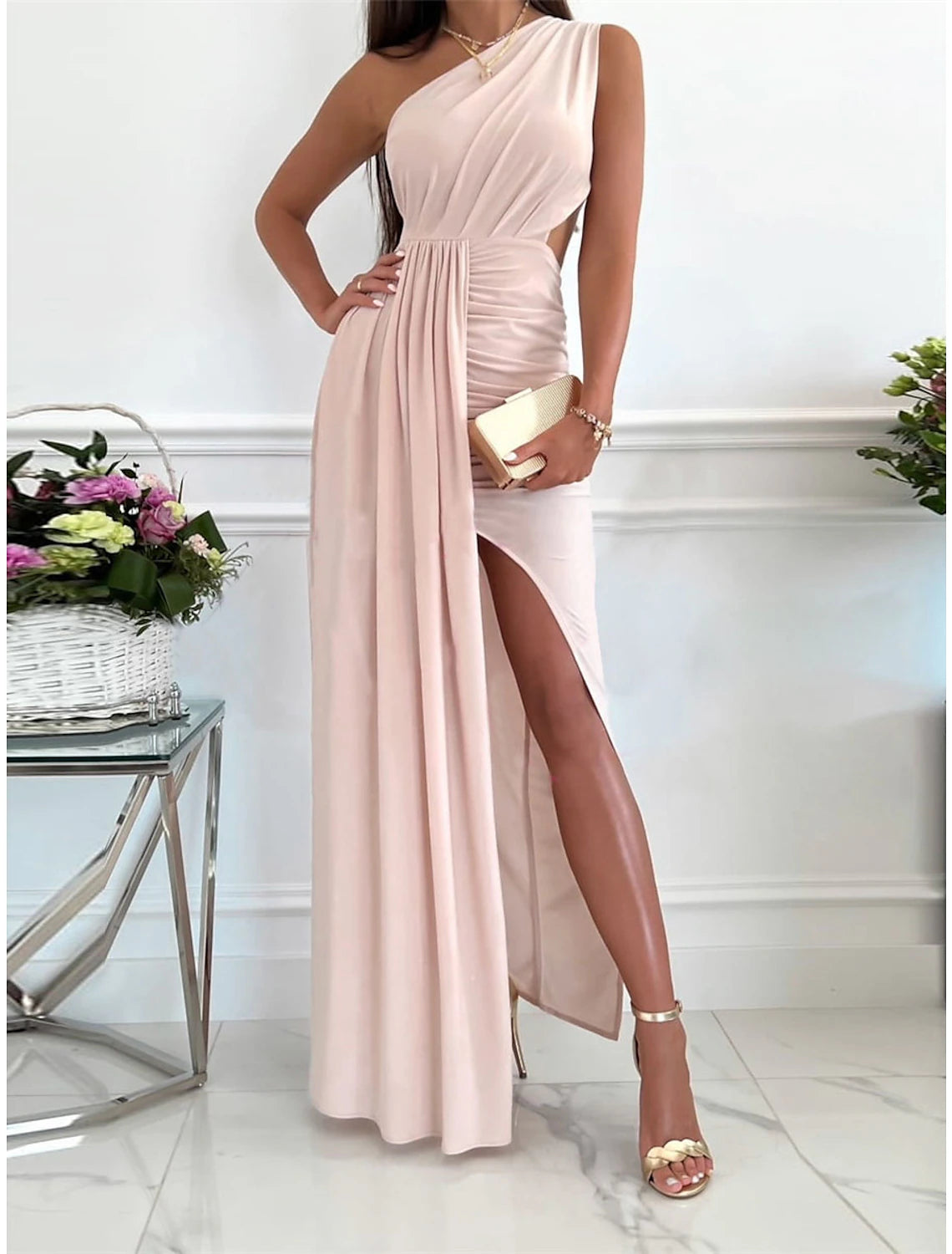 Woman wearing a pink Weitese one-shoulder backless maxi dress.