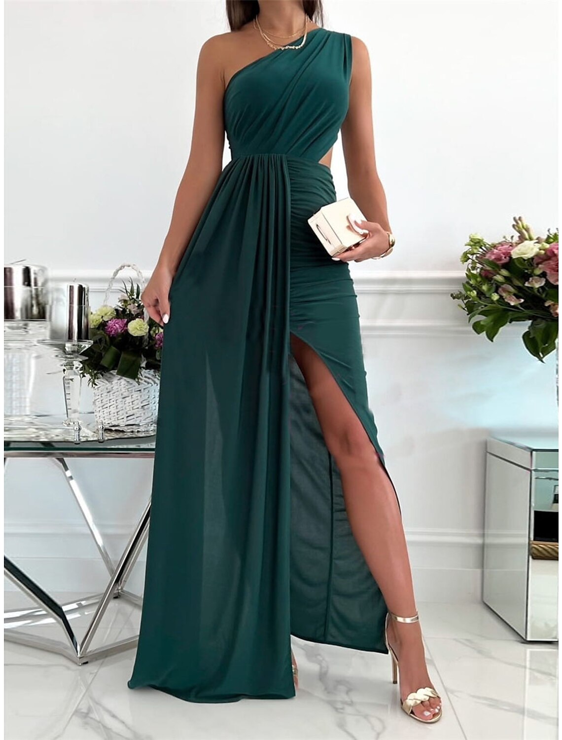 Woman wearing a green Weitese one-shoulder backless maxi dress.