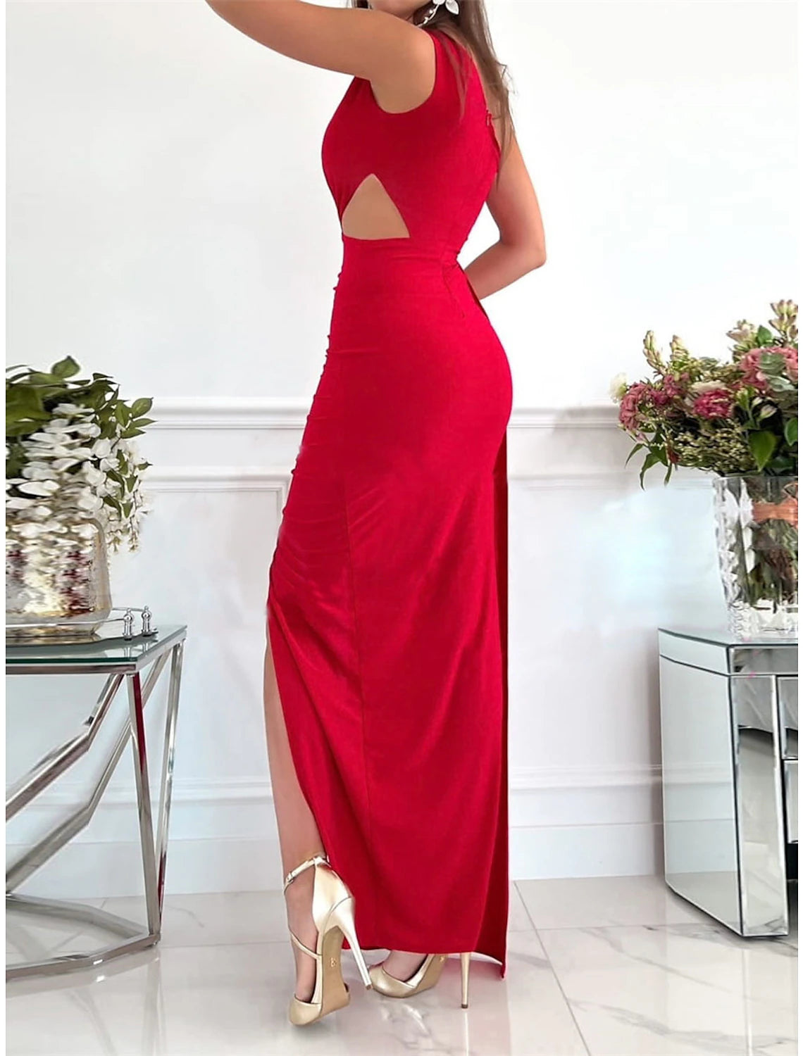 Close-up of a woman in a green Weitese one-shoulder backless maxi dress.