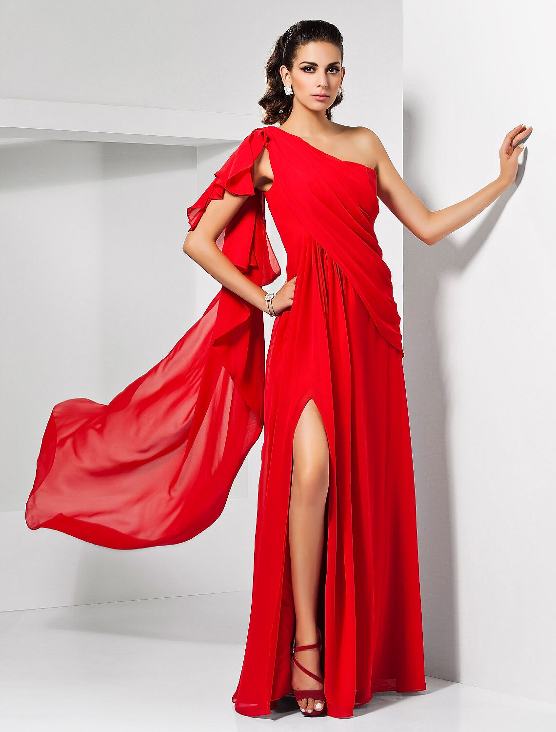 Woman wearing an elegant one-shoulder chiffon sheath column dress with a slit.