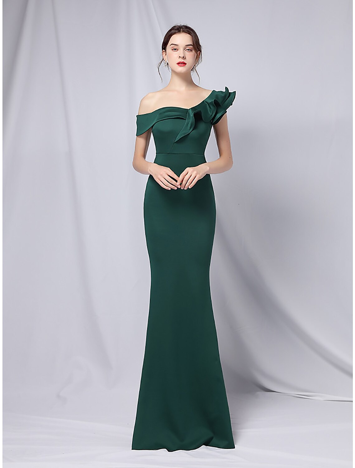 Model wearing a Weitese one-shoulder mermaid trumpet evening gown with ruffles.