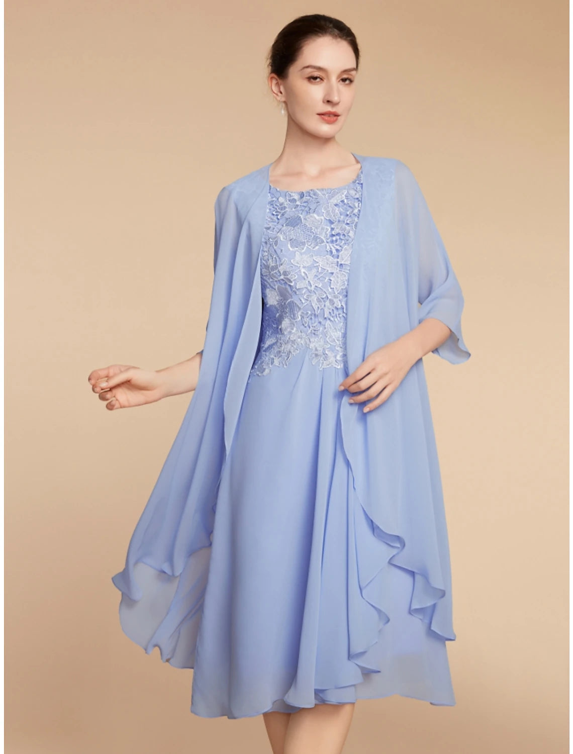 Woman in elegant two-piece sheath dress with scoop neck and half sleeves.