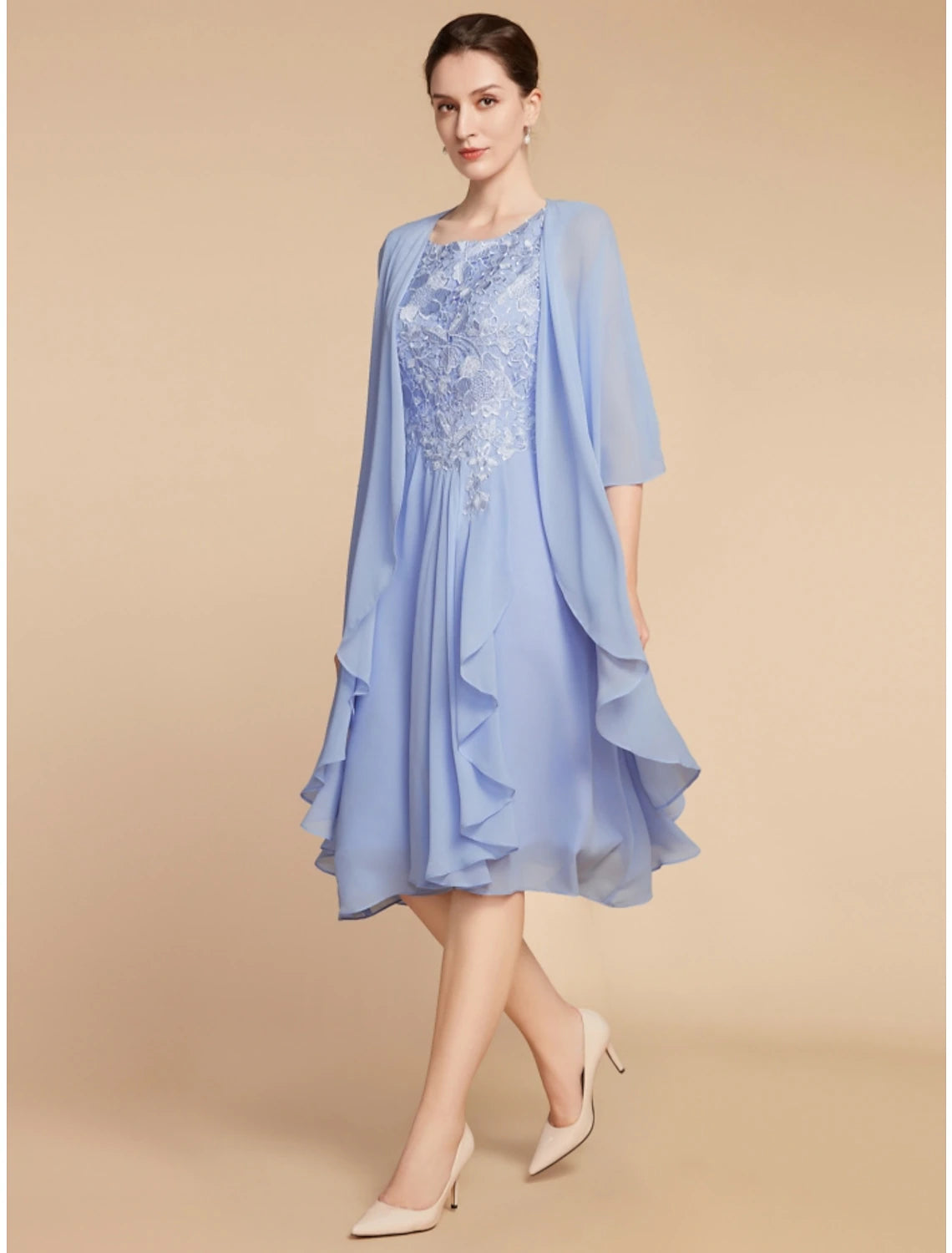 Back view of woman in solid color sheath dress with lace details.