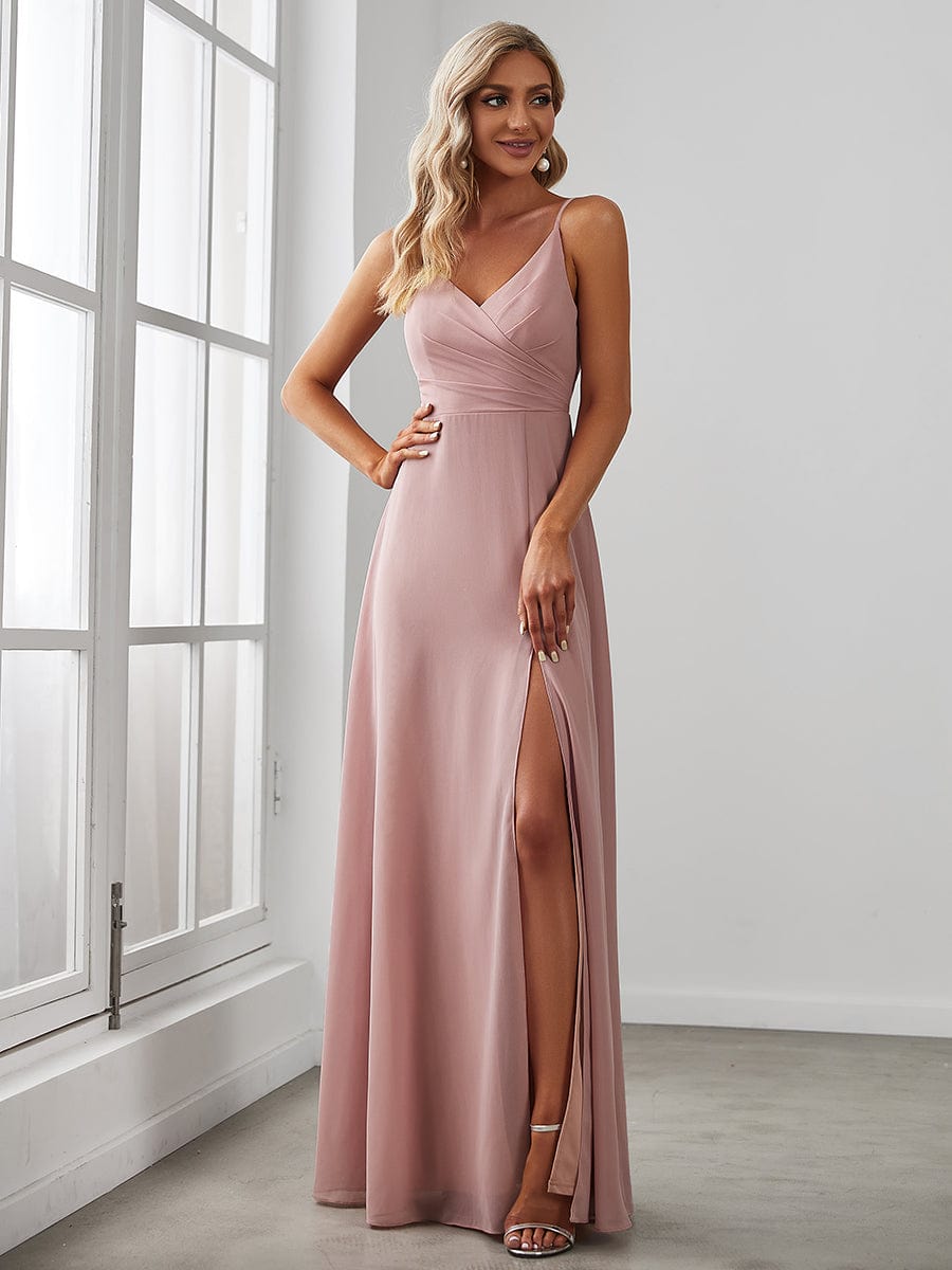 Model wearing a red Weitese pleated V-neck spaghetti strap bridesmaid dress with a high slit.