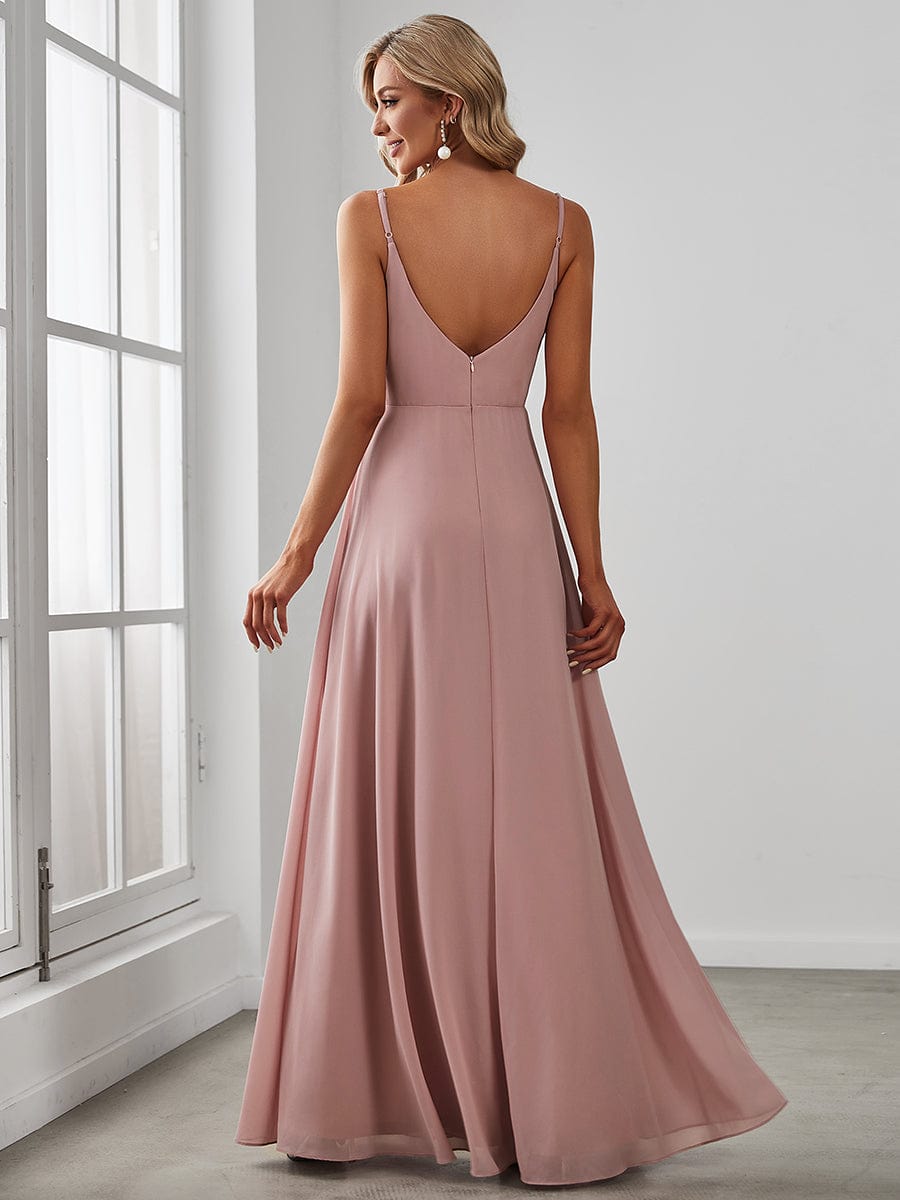 Side view of a model in a red Weitese pleated V-neck spaghetti strap dress.