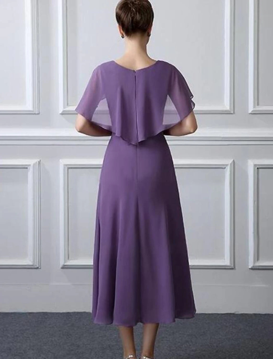 Side view of chiffon tea-length dress with ruffles and ruching.