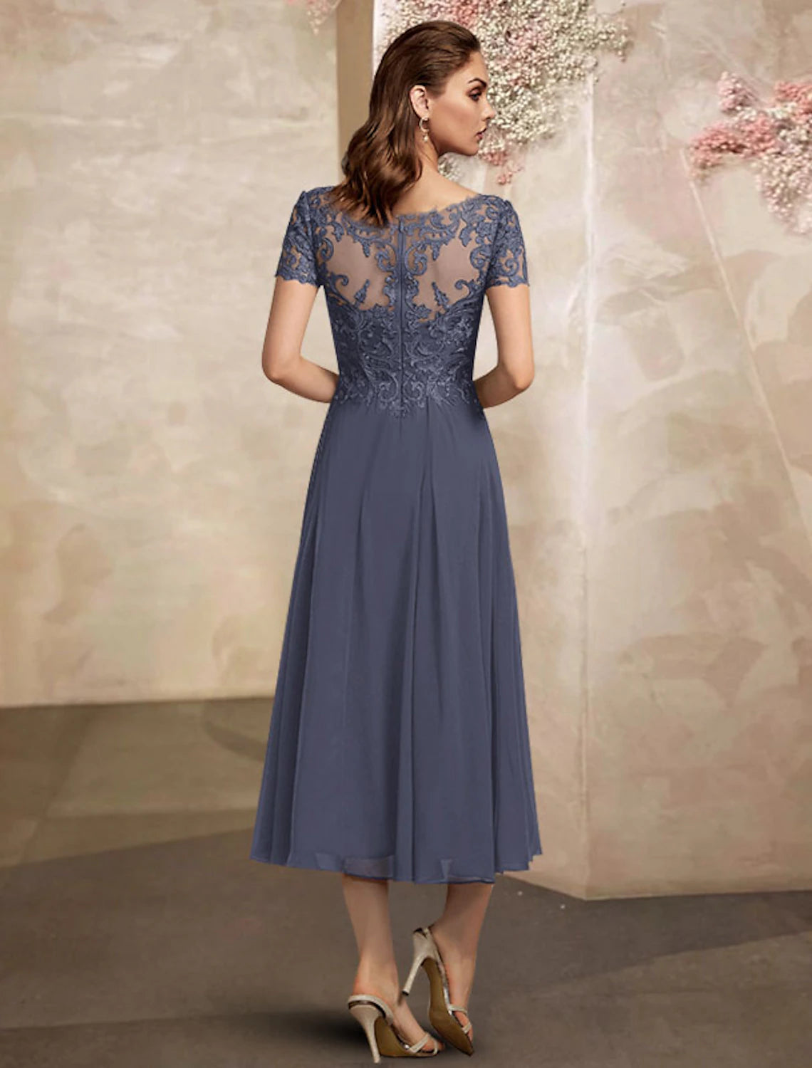 Back view of the elegant plus size A-line Mother of the Bride dress with pleated chiffon and lace details.