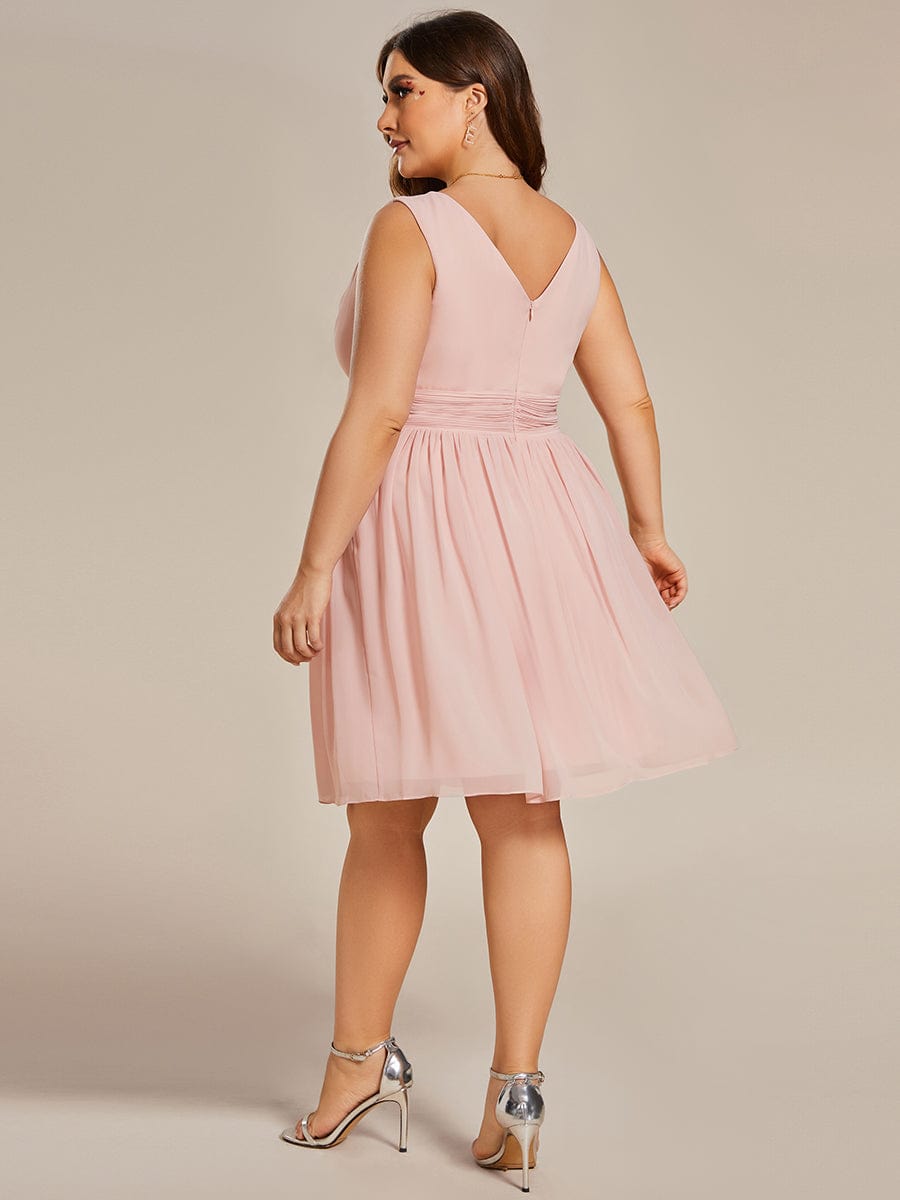 Side view of a plus size pink chiffon bridesmaid dress.