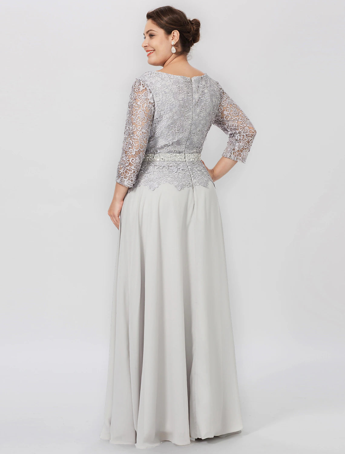 Woman wearing an elegant light blue plus size sheath mother of the bride dress, side view.