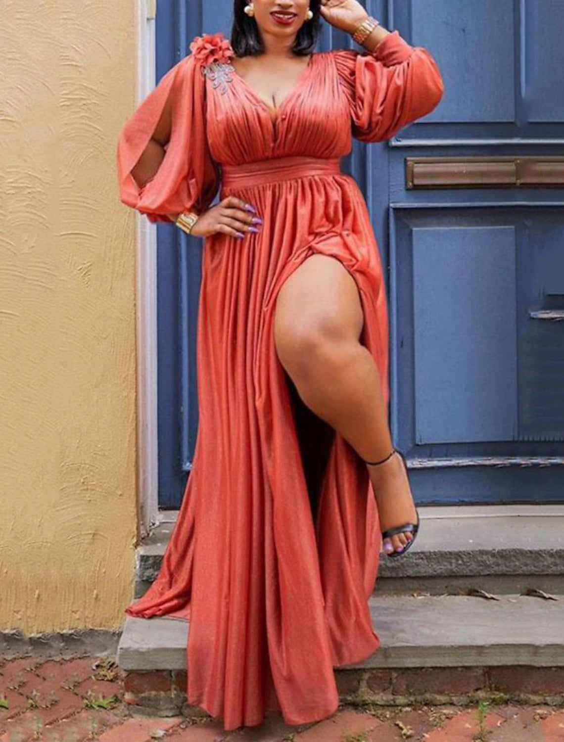 Back view of a woman in an elegant plus size V-neck ruched maxi dress.