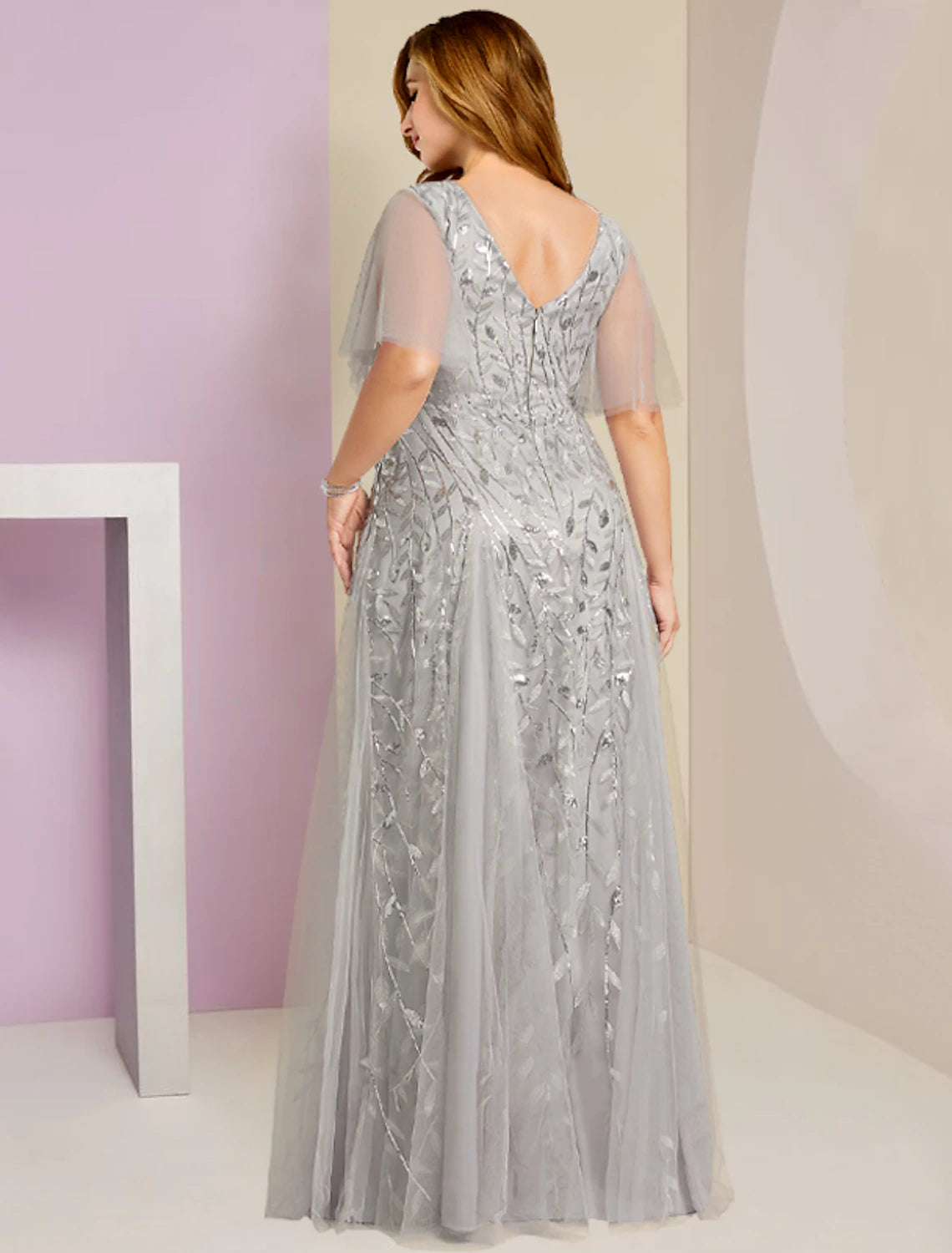 Side view of the Weitese plus size formal gown, showcasing the intricate lace and sequin embellishments.