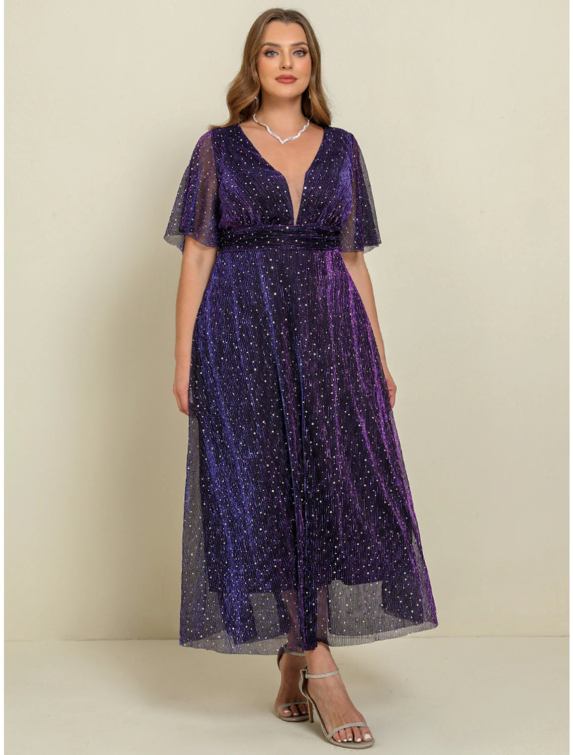 Woman wearing a purple plus size A-line V-neck short sleeve maxi dress.