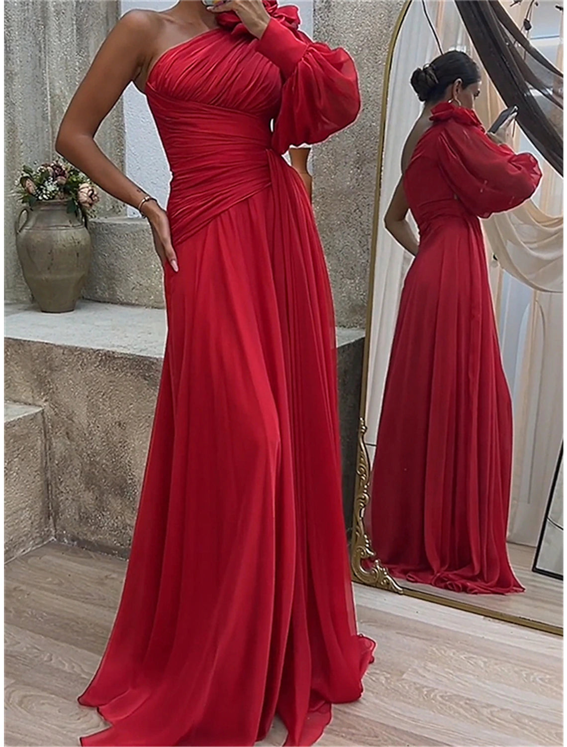Woman posing in a red ruched one-shoulder long sleeve maxi dress, full length.