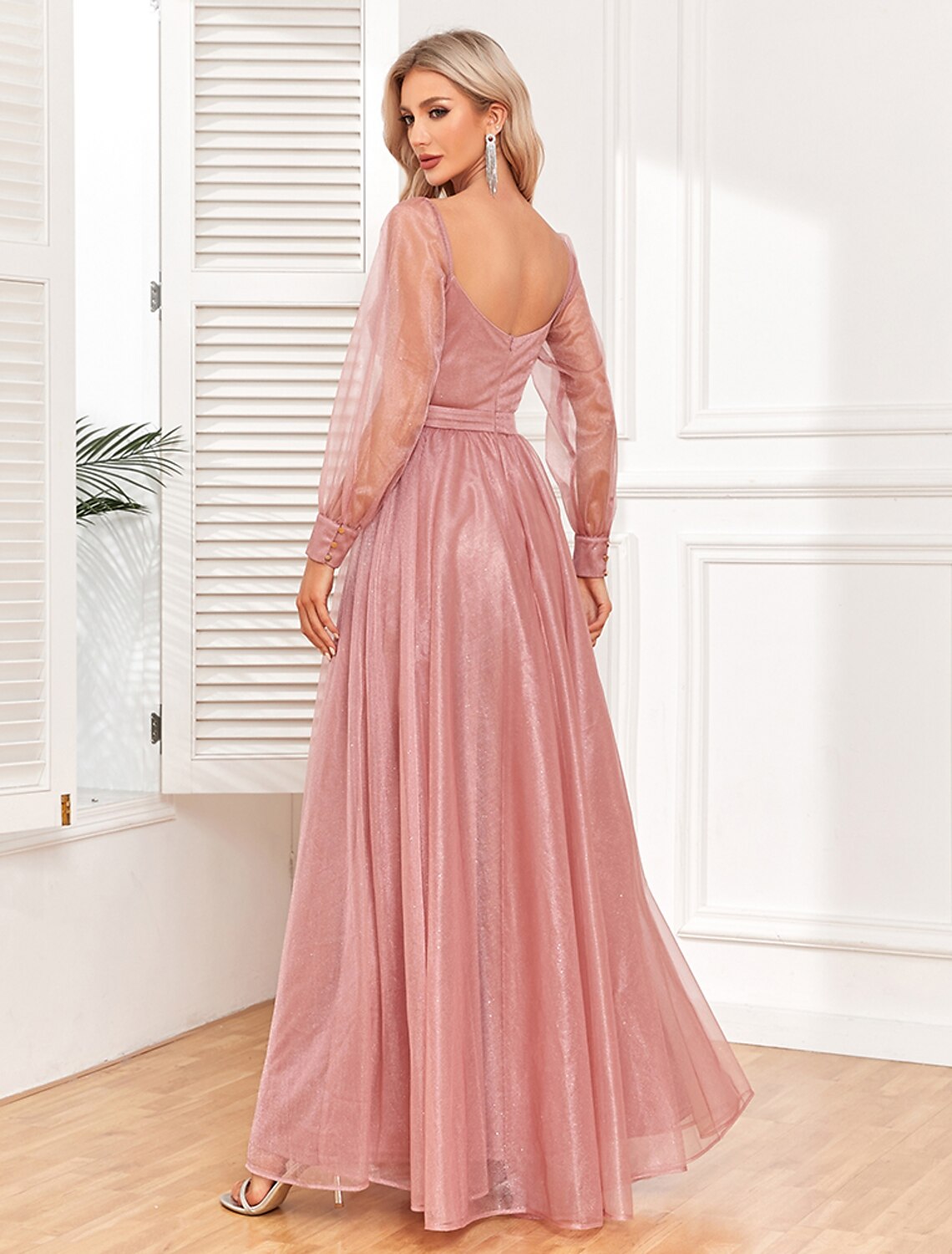Side profile of a woman in the light red formal maxi dress.