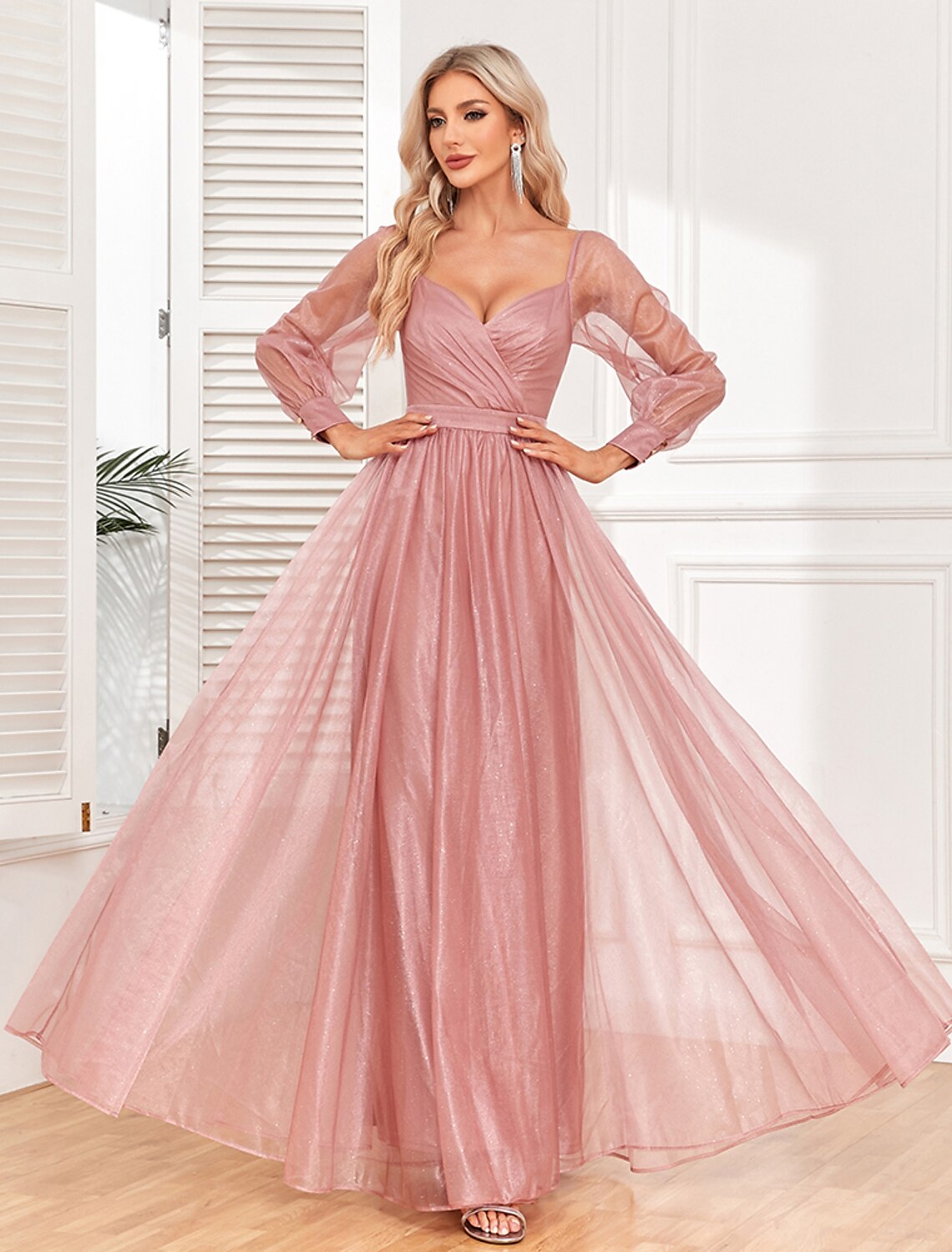 Close-up of the ruched detail and V-neck on the light red dress.