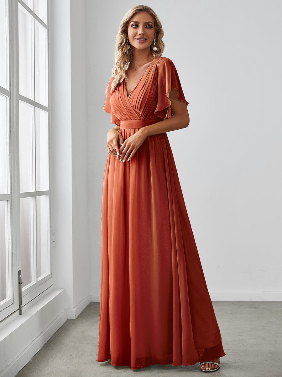 Close-up of ruffle sleeve and V-neck on red chiffon dress.