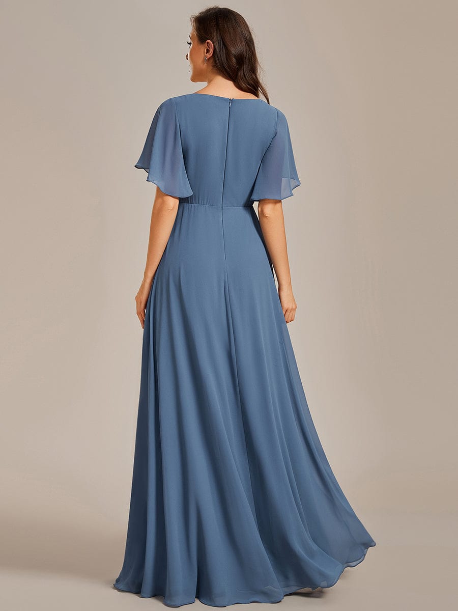 Woman posing in a dark blue Weitese chiffon maxi dress with ruffle sleeves.