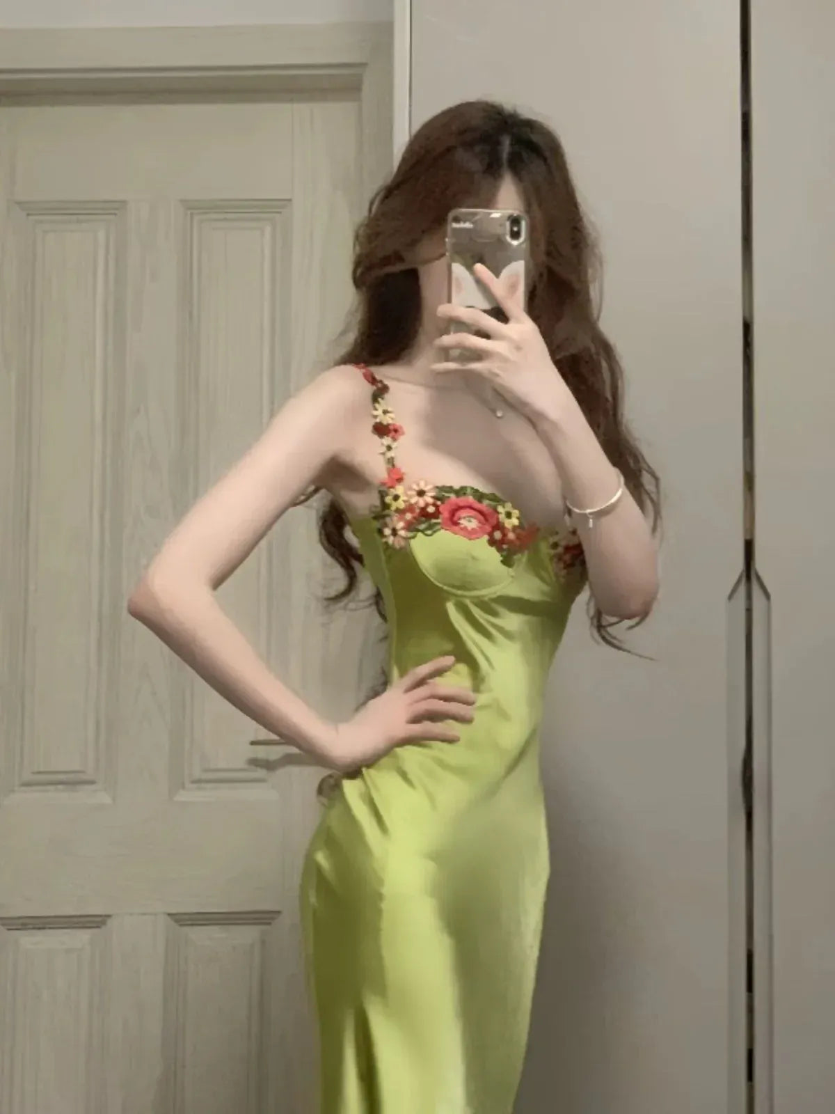 Back view of the sage green satin mermaid dress, highlighting its sleek silhouette.