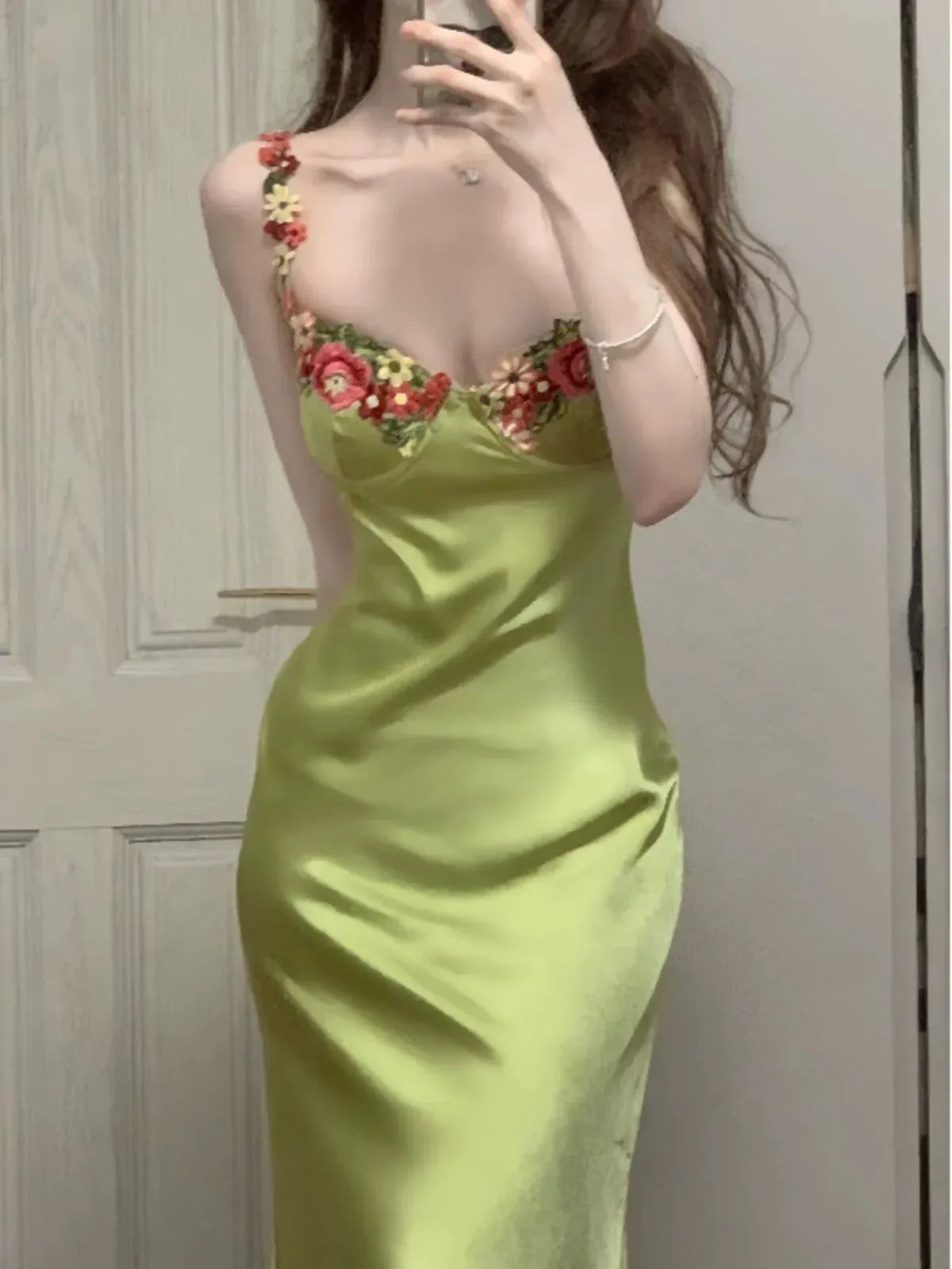 Full-length view of the sage green mermaid dress, showcasing its flowing hem.