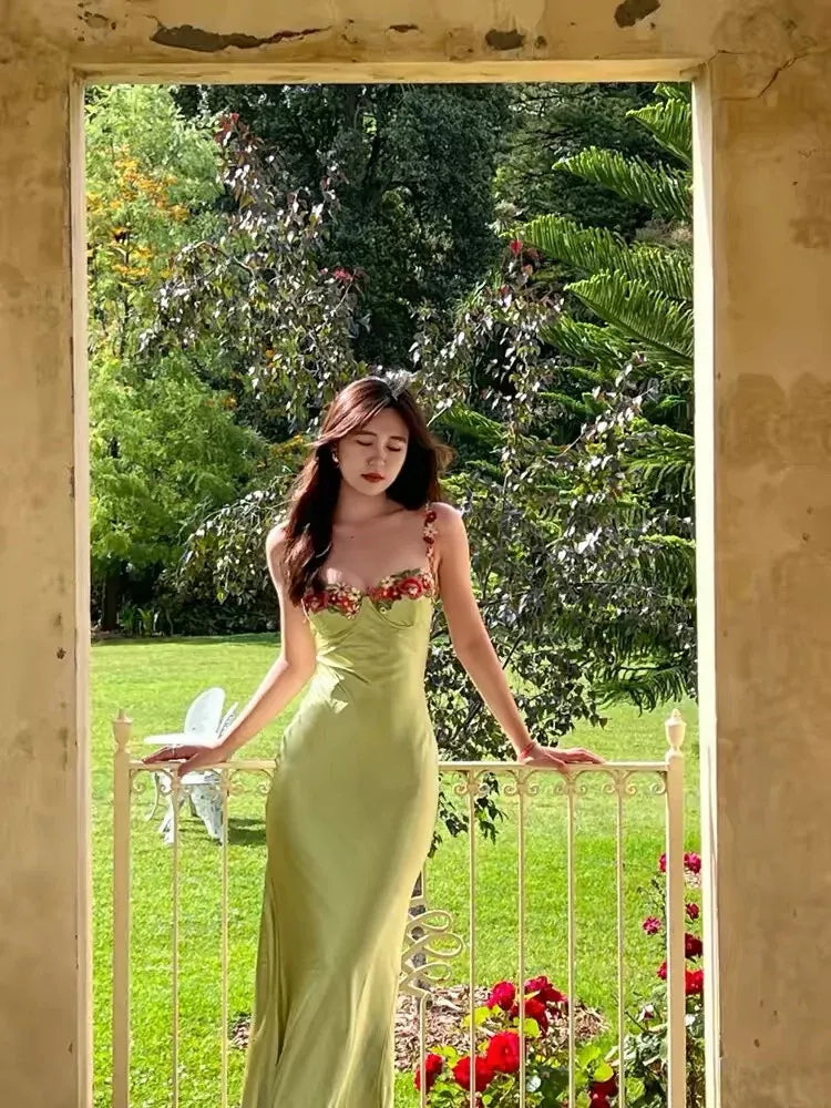 Model gracefully posing in the sage green satin mermaid evening dress.