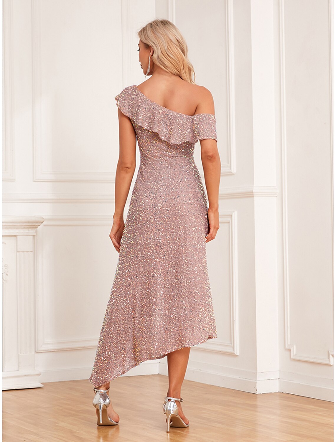 Model wearing a khaki sequin cold shoulder ruched midi dress, side view.