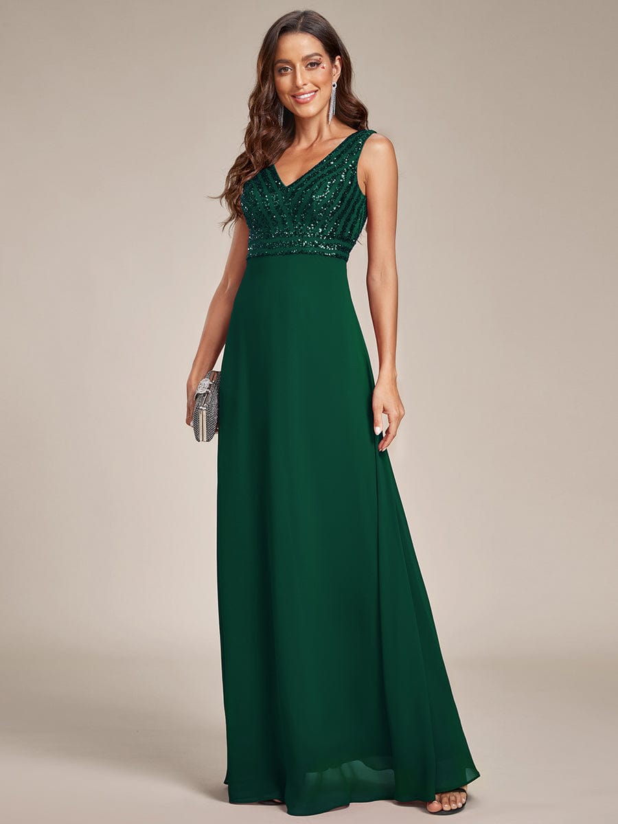 Close-up of sequin detail on a dark green formal dress.