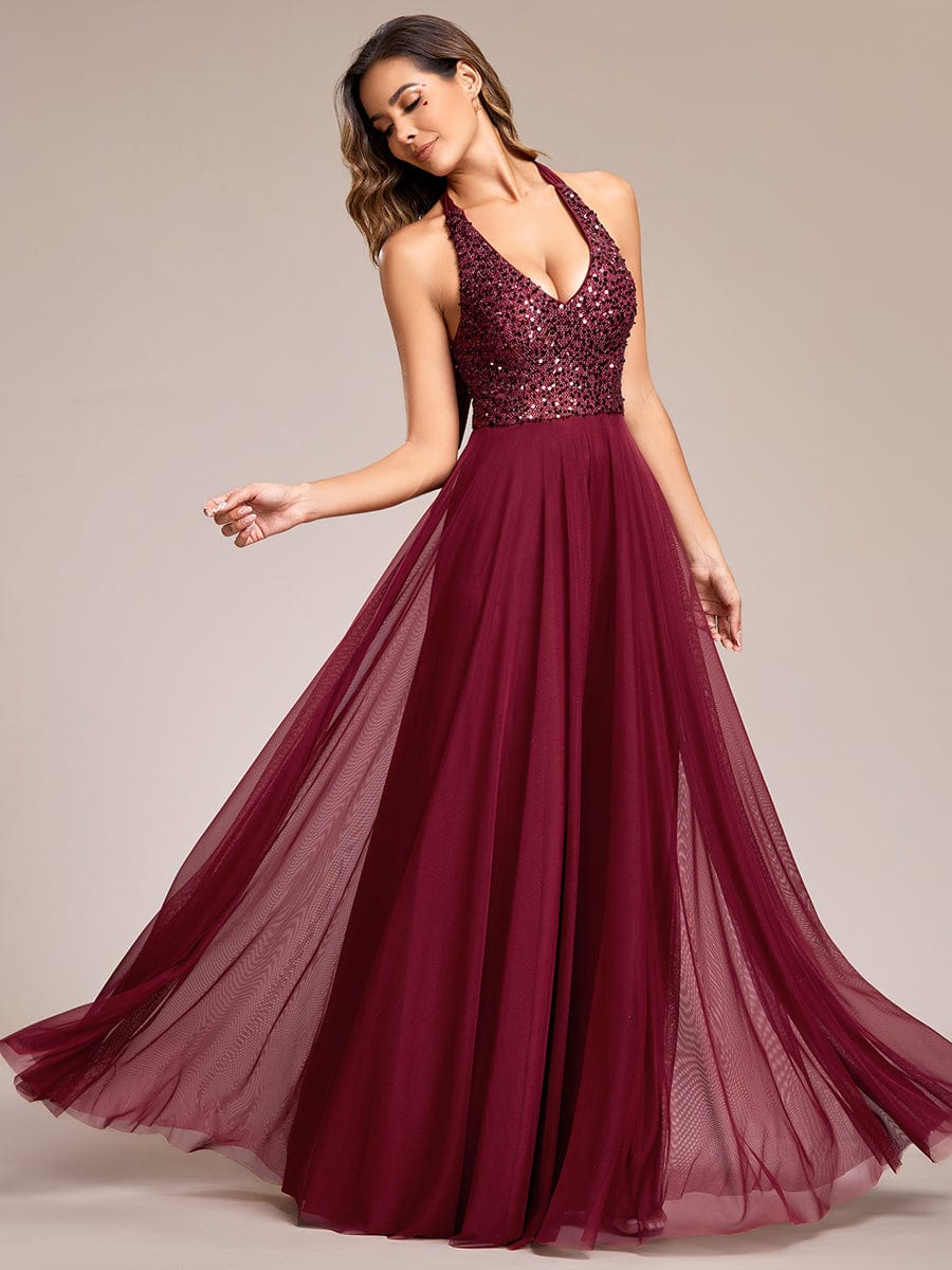 Model wearing a red sequin halter neck A-line backless dress with tulle skirt.