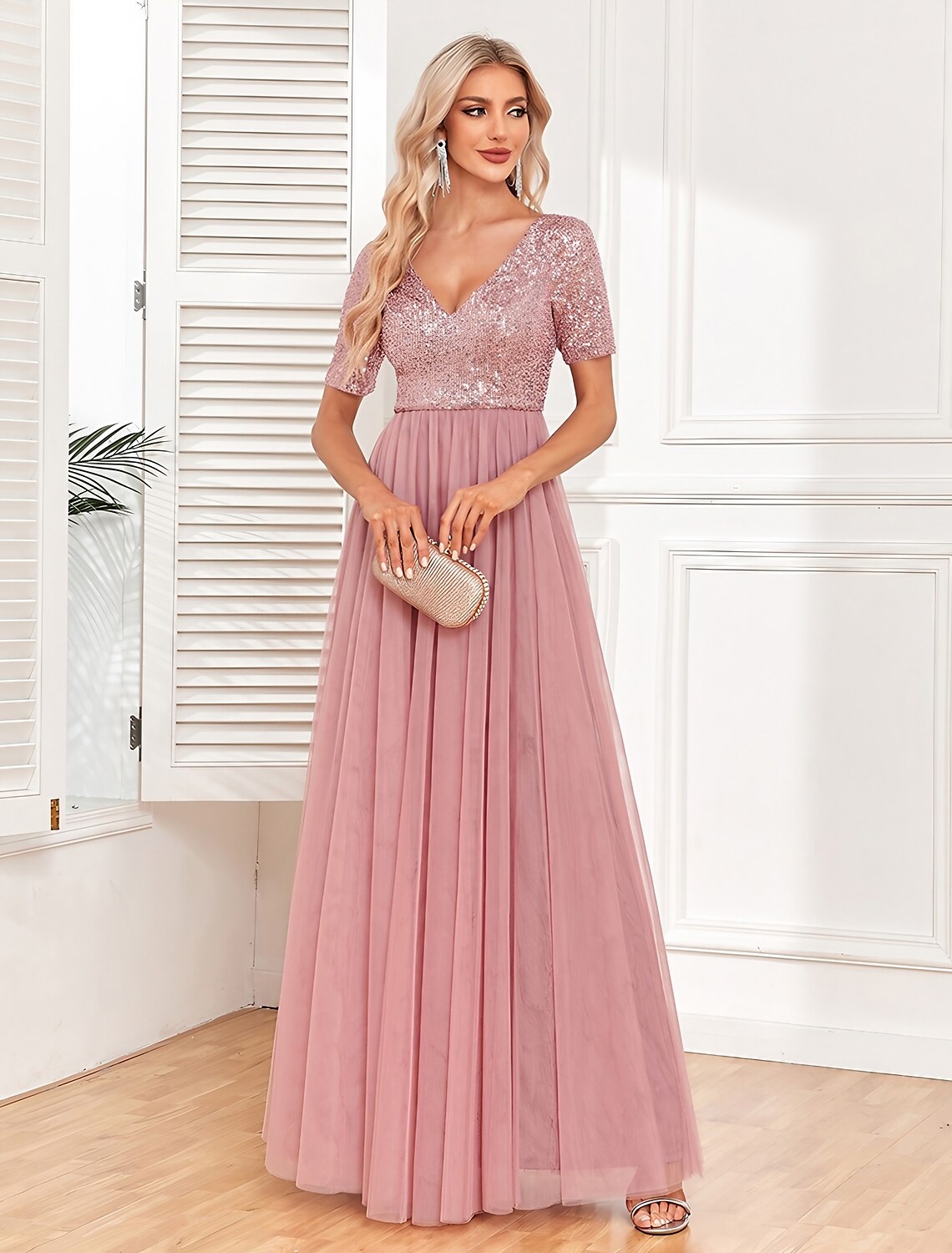 Woman wearing a pink sequin V-neck short sleeve maxi dress.