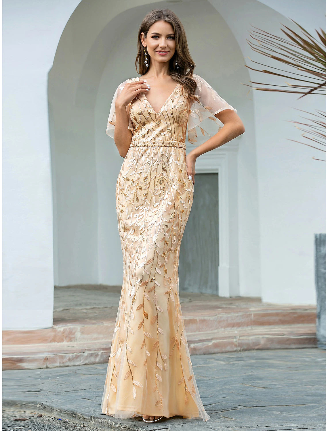 Elegant sequin mermaid trumpet gown with V-neck and short sleeves, worn by a model.