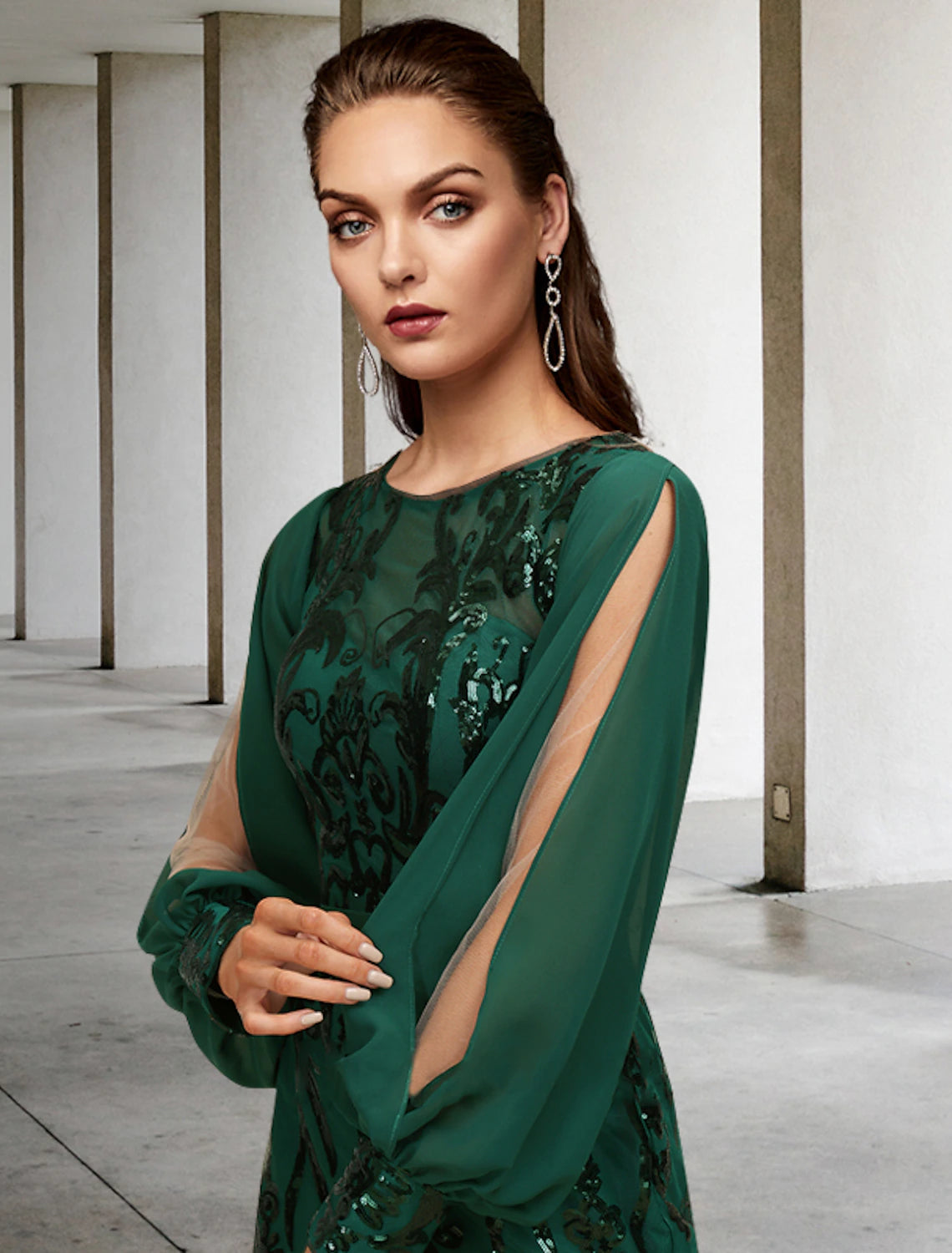 Model wearing the elegant long sleeve mermaid dress, showcasing its flowing chiffon.