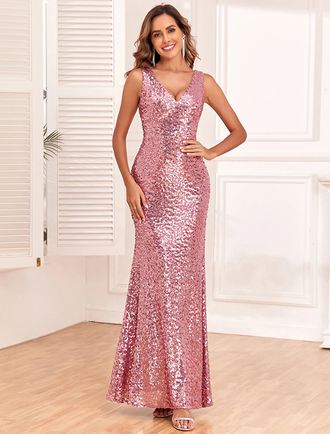 Front view of an elegant sequined mermaid V-neck backless evening gown.