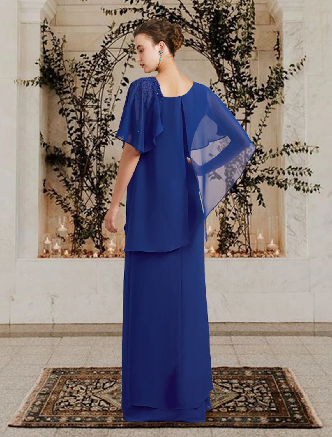 Close-up of the elegant Mother of the Bride dress, highlighting the bateau neckline, short sleeves, and intricate beading.