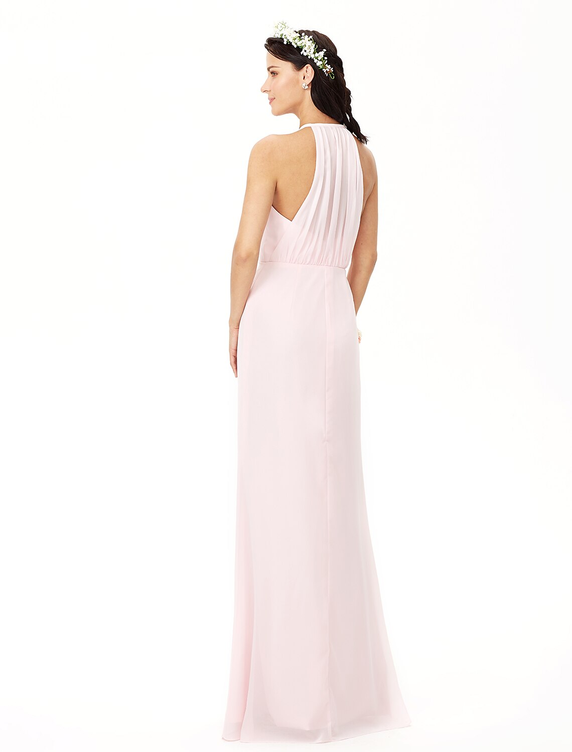 Back view of a woman in an elegant floor-length chiffon bridesmaid dress.