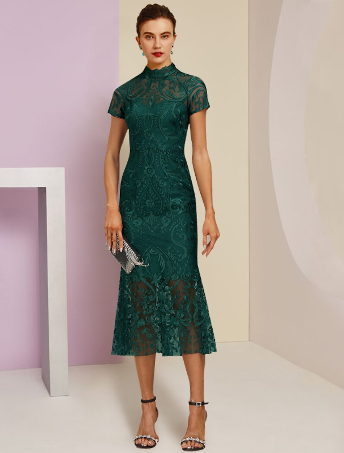 Elegant high neck tea length sheath dress with lace and appliques, worn by a model.