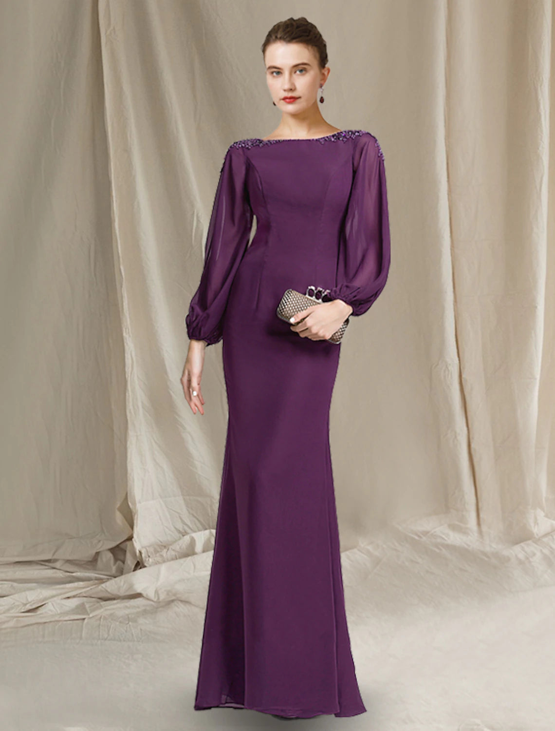 Elegant Weitese sheath column mother of the bride dress with jewel neck, long sleeves, and beading.
