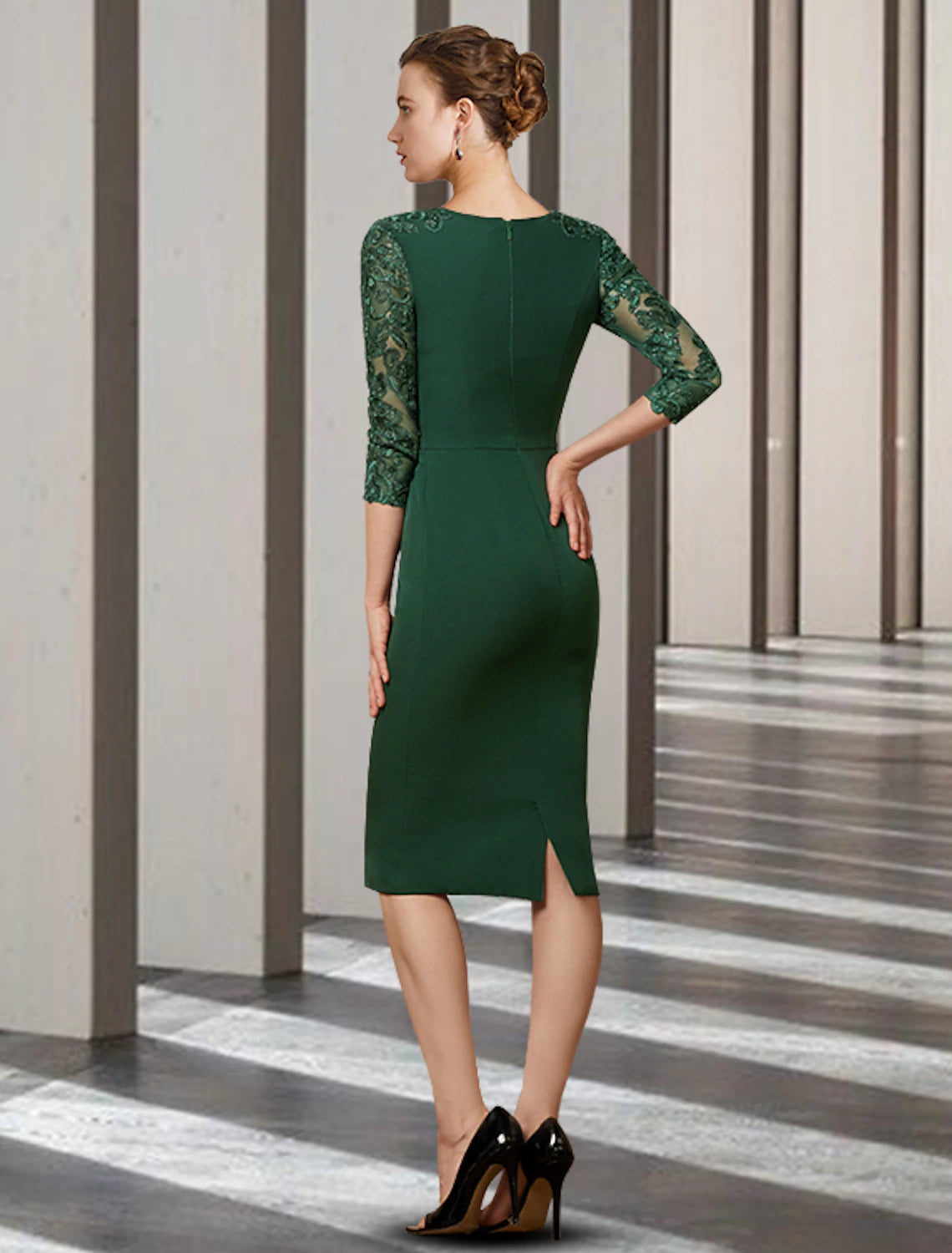 Side view of a woman in a sophisticated short sheath dress with long chiffon lace sleeves and appliques.