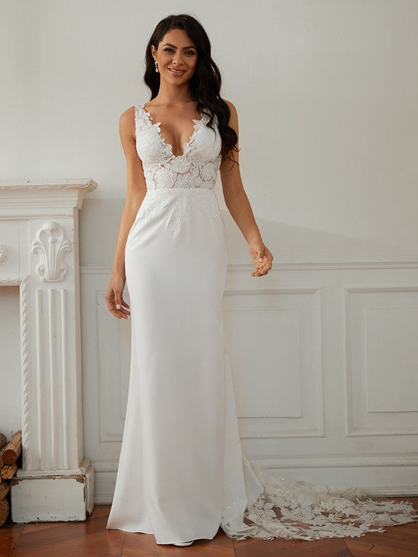 Side profile of a bride wearing a sophisticated sheath wedding gown.