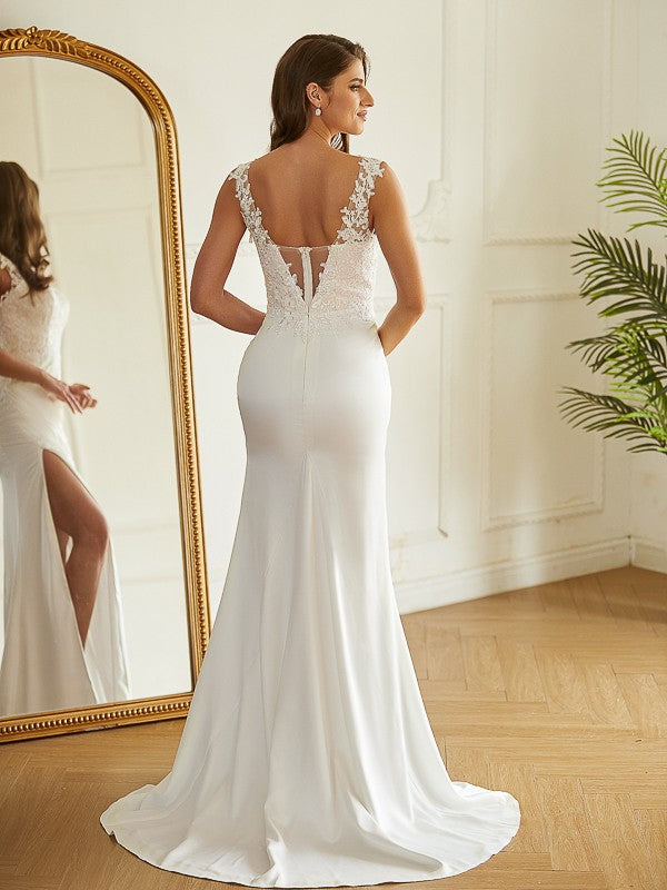 Close-up of the lace V-neckline and sleeveless design of the wedding dress.