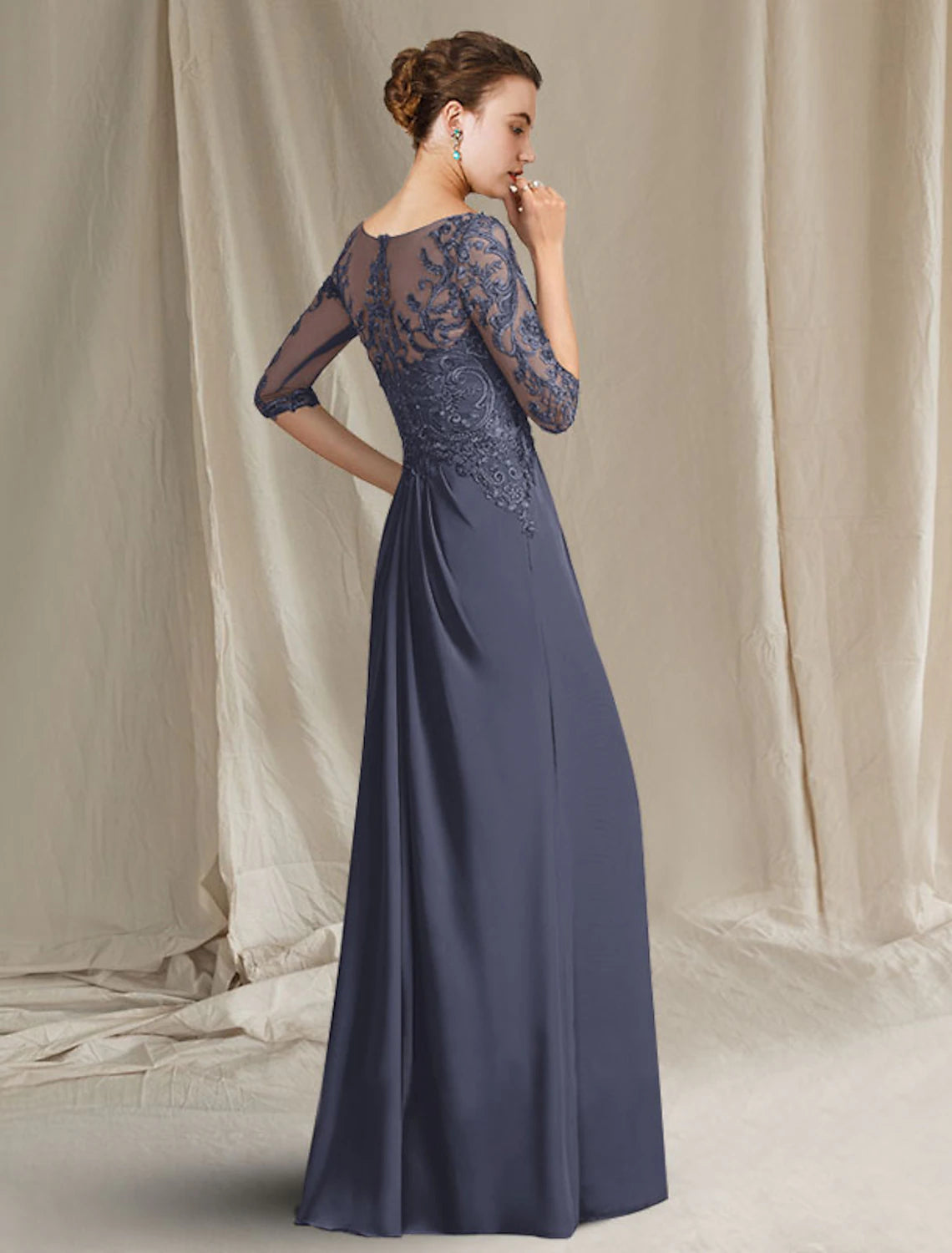 Close-up of the back of the elegant sheath column dress, showing the lace and pleat details.