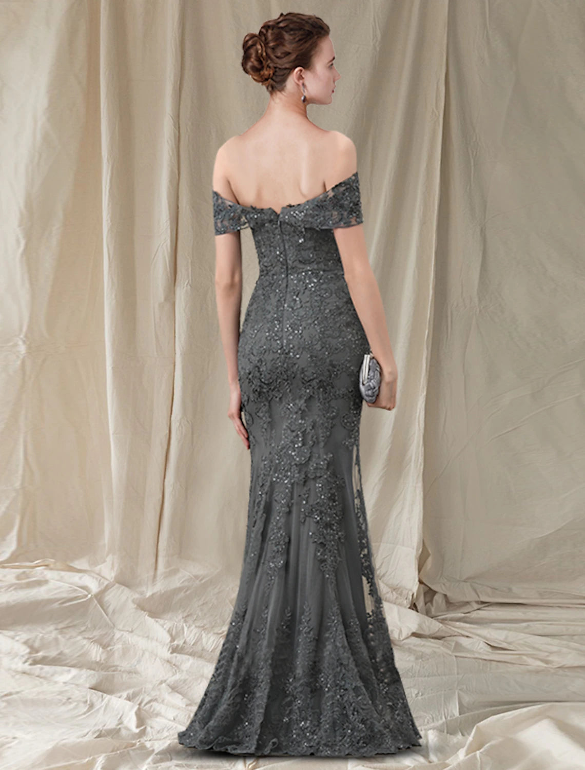Close-up of the sequined lace and pleat details on the off-shoulder Mother of the Bride dress.